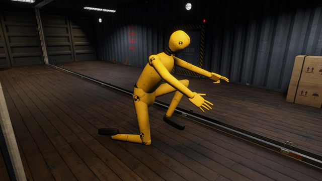 Un mannequin de crash-test jaune, figé à genoux sur le plancher d'un conteneur.